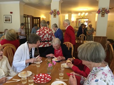 Residents engaged in a lively social gathering in the dining room
