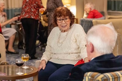 Residents engaged in conversation in a common area