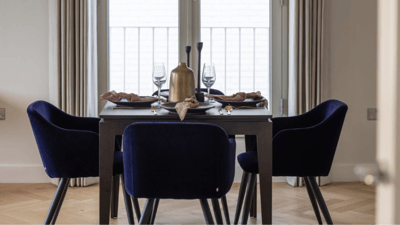 An elegantly set dining table with chairs
