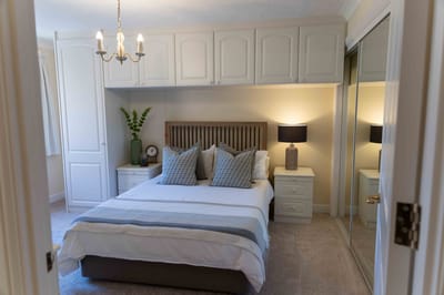 Cozy bedroom with a comfortable bed and dresser