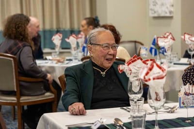 Elderly resident enjoying a meal in a dining room setting