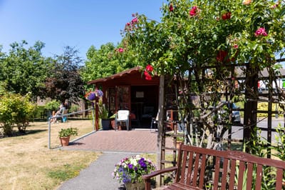 Residents enjoying outdoor space with benches and flowers