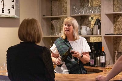 Staff member serving drinks in a common area