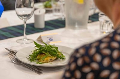 A plated meal with a resident in focus