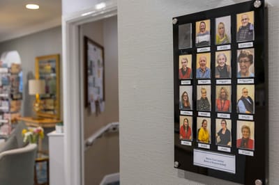 Photo collage of staff members displayed in the hallway