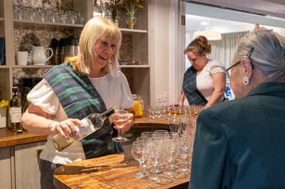 Staff pouring drinks for residents during an event