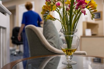 A cozy common area with flowers in a glass vase