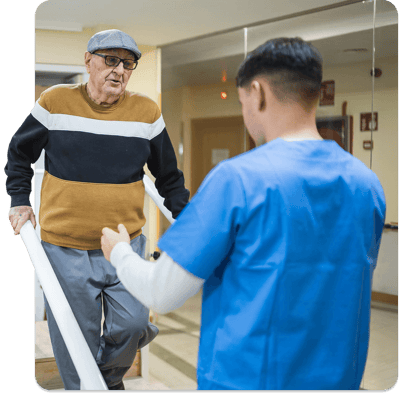 Staff assisting a resident in a hallway