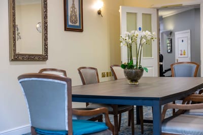 Dining area with a large table and floral centerpiece