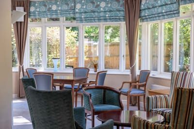 Common area with chairs and tables in a bright room
