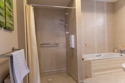 A bathroom with a shower and bathtub
