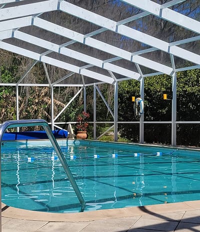 Indoor pool area with clear water and seating