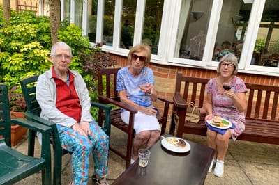 Residents enjoying snacks and drinks in the garden