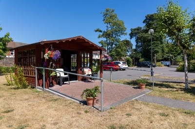 Exterior view of a retirement community building with outdoor seating