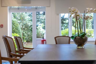 Bright common area with a floral centerpiece and outdoor views
