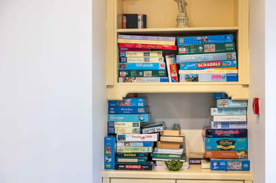 Shelves filled with board games and puzzles