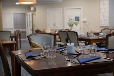 Dining room set for a meal with floral centerpiece