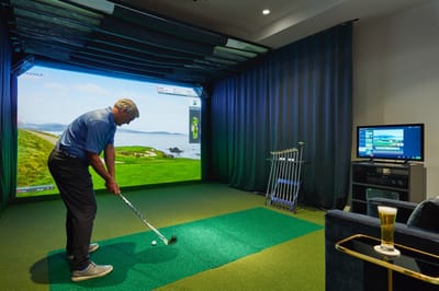 Resident enjoying a golf simulator activity indoors
