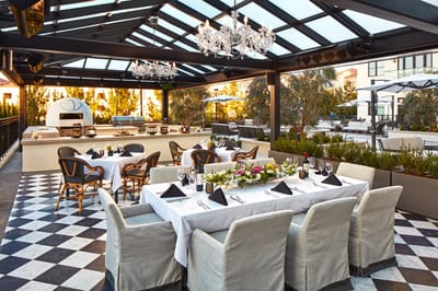 Elegant outdoor dining area with a set table and decor