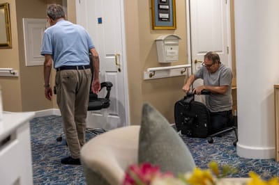 Residents interacting in a common area with staff.