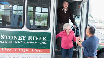 Residents interacting while exiting a facility shuttle