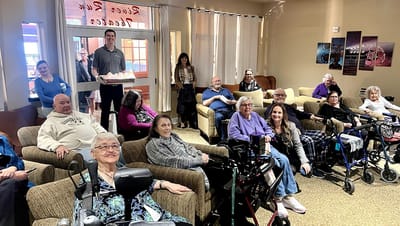 Residents and staff in a cozy common area