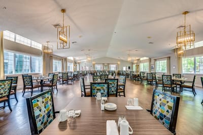 Bright dining room with tables set for meals