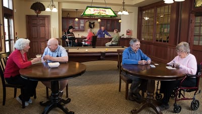 Residents enjoying games in a common area with billiards