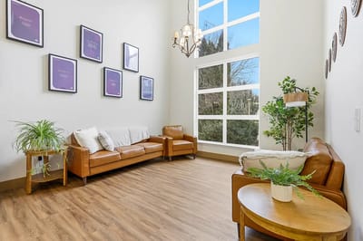 Bright common area with seating and large windows