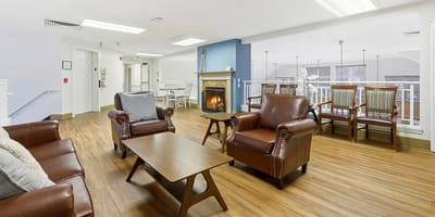 Common area with chairs and a fireplace