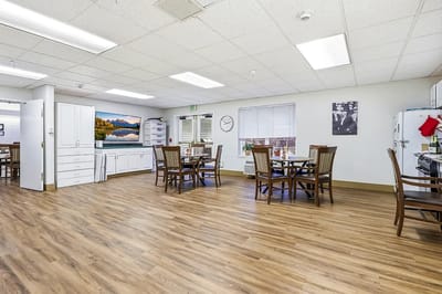 Bright common area with dining tables and artwork