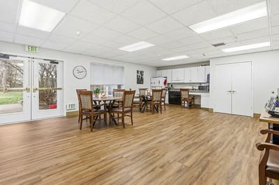 Bright common area with dining tables and kitchenette
