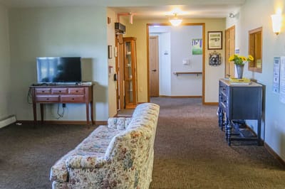Common area with floral couch and TV