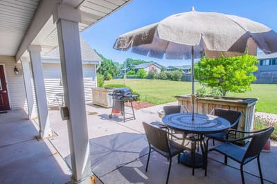 Outdoor patio area with table and umbrella