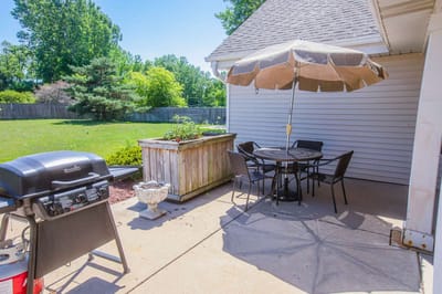 Outdoor seating area with grill and umbrella