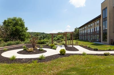 Outdoor space with landscaped gardens and building nearby