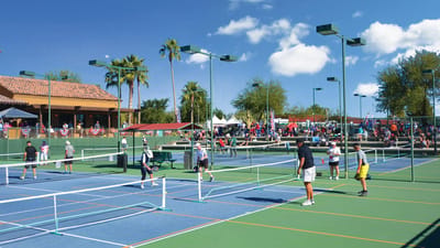 Residents playing tennis on outdoor courts