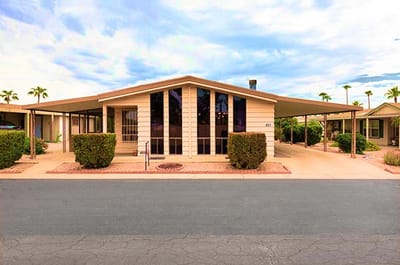 Exterior view of a facility with landscaping and parking area