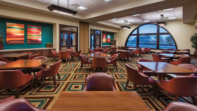 Dining room with tables and chairs in a bright space