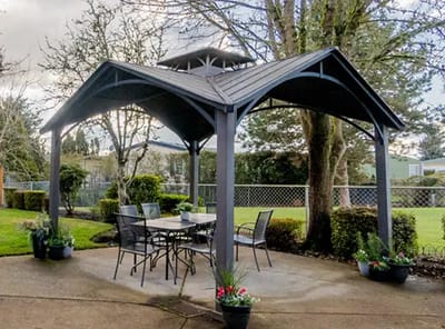 Outdoor gazebo with chairs and tables in a garden