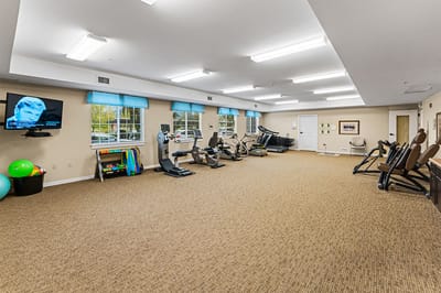 Fitness area with exercise equipment in a bright room
