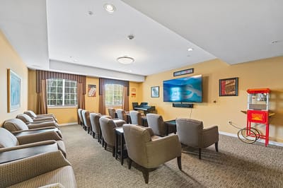 Common area with comfortable seating and a large screen