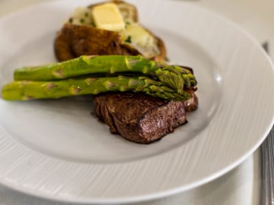 Mirador, Nursing Home in Corpus Christi, TX — Plated gourmet meal with steak, asparagus, and baked potato