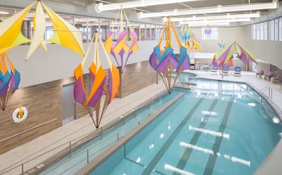 Indoor pool with colorful decorations overhead