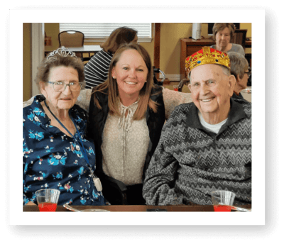 Residents celebrating with staff in a common area.