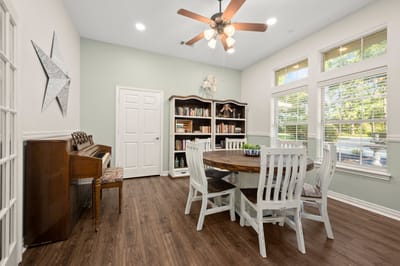 Common area with a dining table and bookshelf