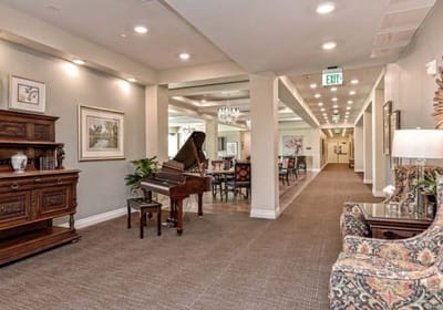 Interior view of a common area with a piano and seating