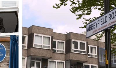 Exterior of a residential building with street sign.