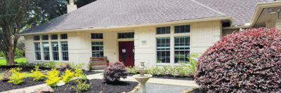 Exterior view of assisted living facility with landscaping.