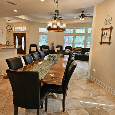Spacious dining area with a large wooden table.
